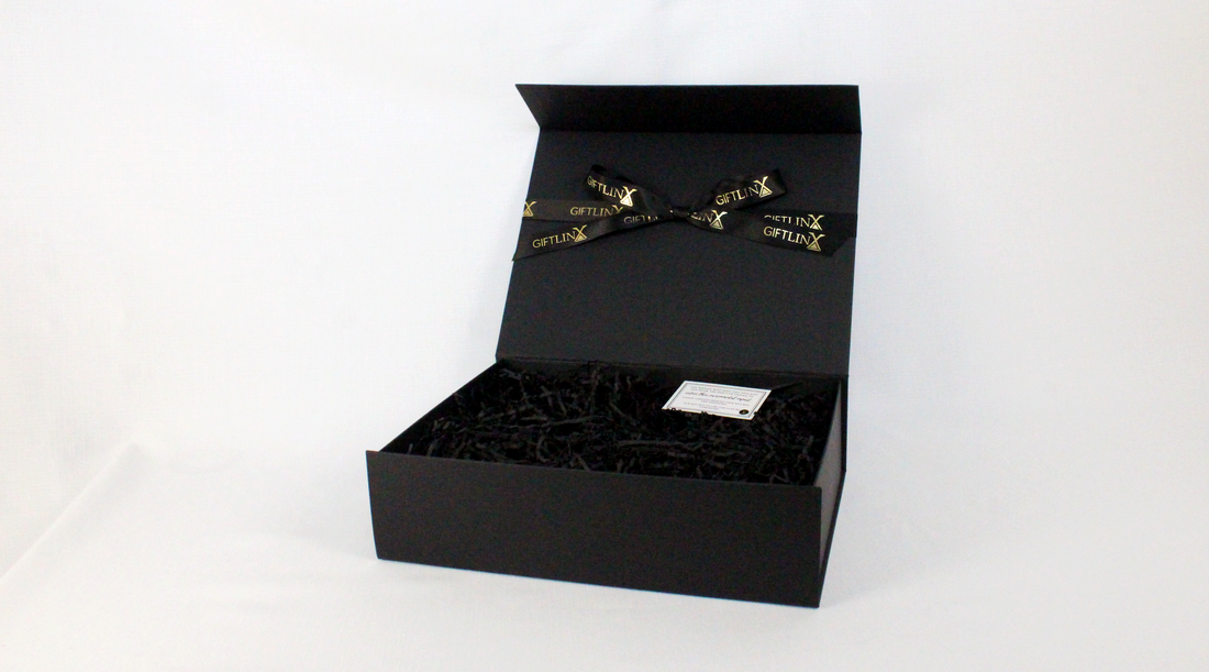 black gift box open with black paper fill inside