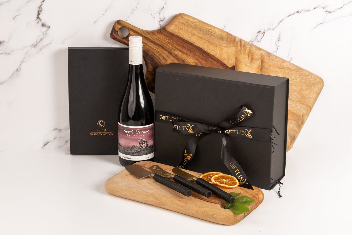 Luxury Black Gift Box with black and gold branded ribbon tied in a bow paired with premium Australian wine, handmade cheese board and cheese knife set