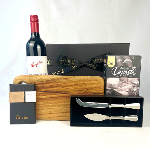 Wine bottle, cutting board, knives, and other items on a white background