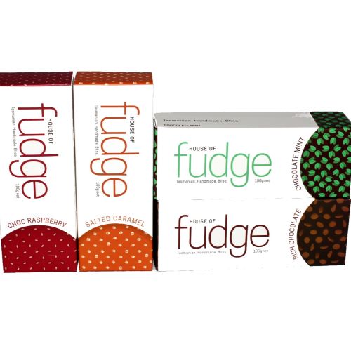 four boxes of fudge lined up together in white and coloured packaging on white background