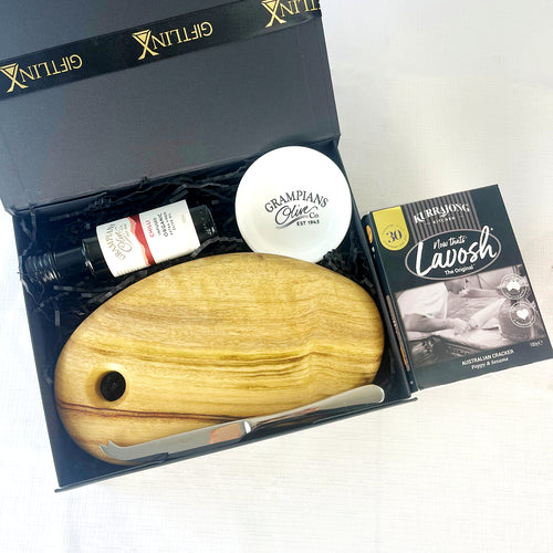 Gift set with wooden tool, bottle, and box on a white background