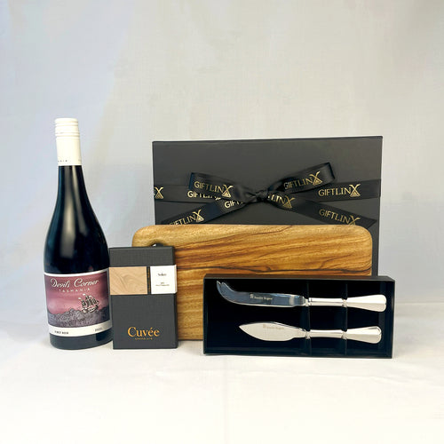 Wine bottle, cutting board, and cheese knives with a GIFTLINX box on a white background