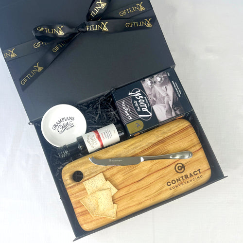 Gift set with a wooden cutting board, knife, and other items in a black box labeled 'GIFTLINX'.