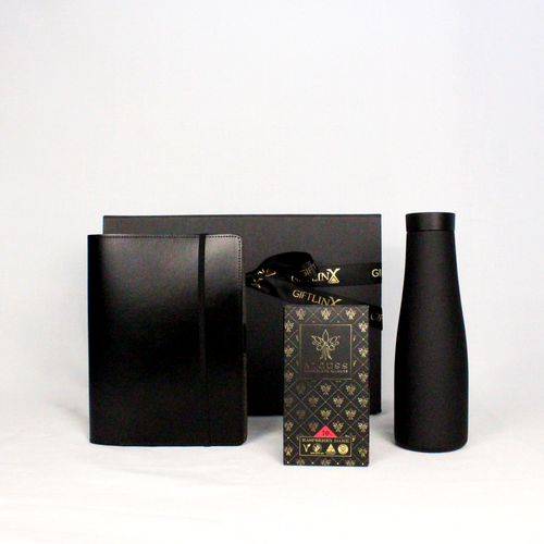 A luxury black magenetic gift box with ribbon containing an Australian made leather notebook holder with pen loop and business card holder, matte black drink flask and handmade Australian chocolate bar.