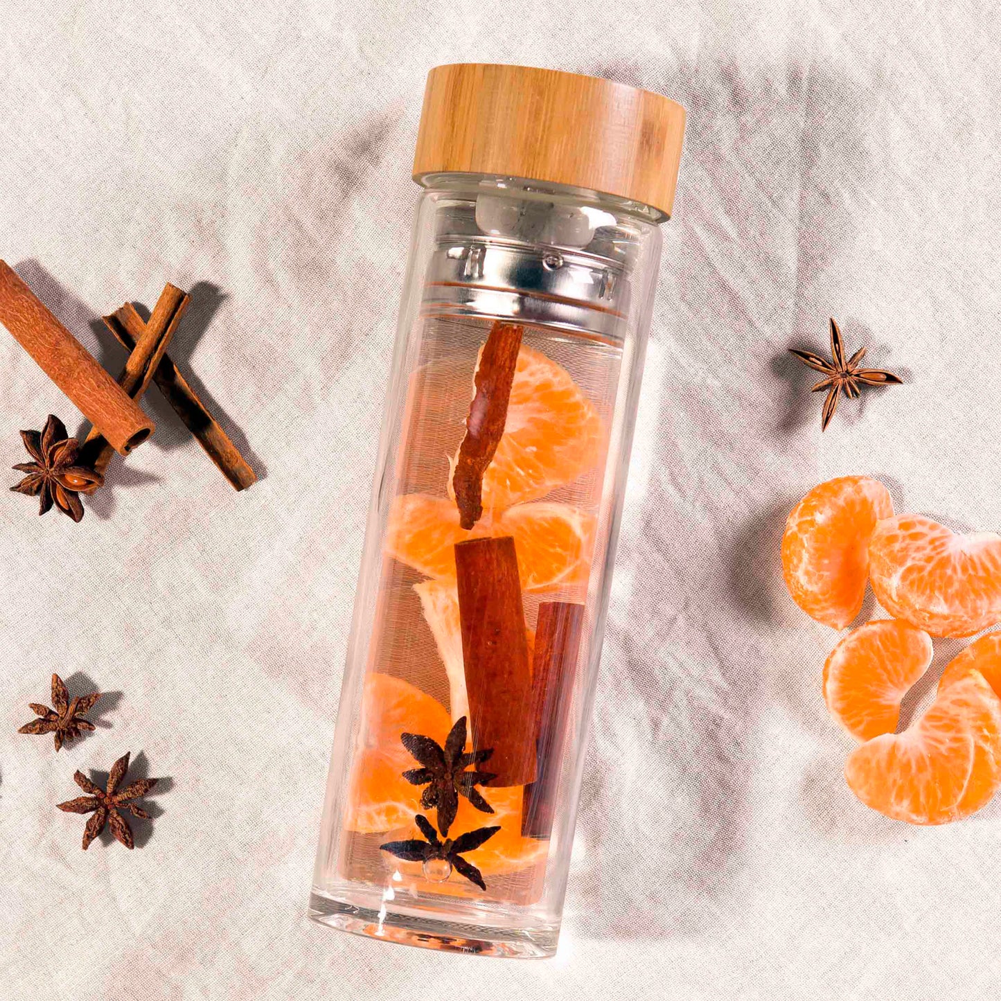 double walled glass drink flask filled with citrus and cinnamon to infuse the water