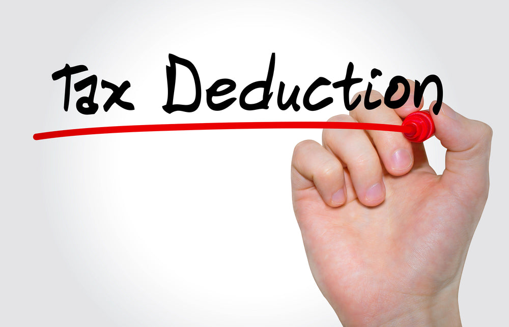 Hand with a red texta underlining the words " Tax Deduction"