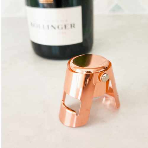 copper champagne stopper on marble bench