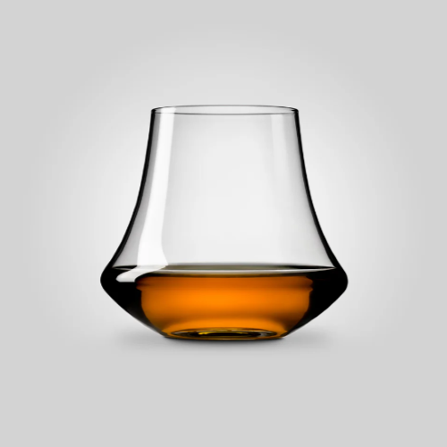 handblown whisky glass with whisky inside on white background