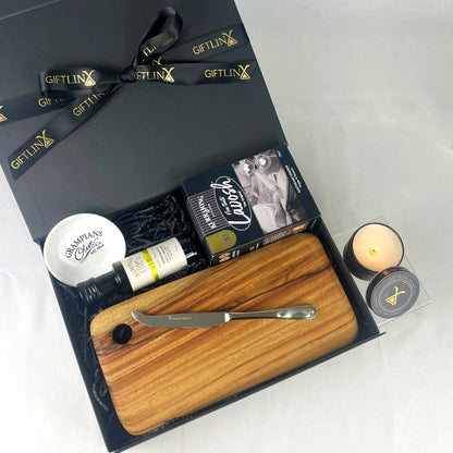 Gift set with wooden cutting board, knife, and other items in a black box labeled 'GIFTLINX'.