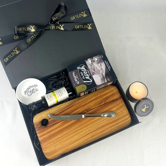 Gift set with wooden cutting board, knife, and other items in a black box labeled 'GIFTLINX'.