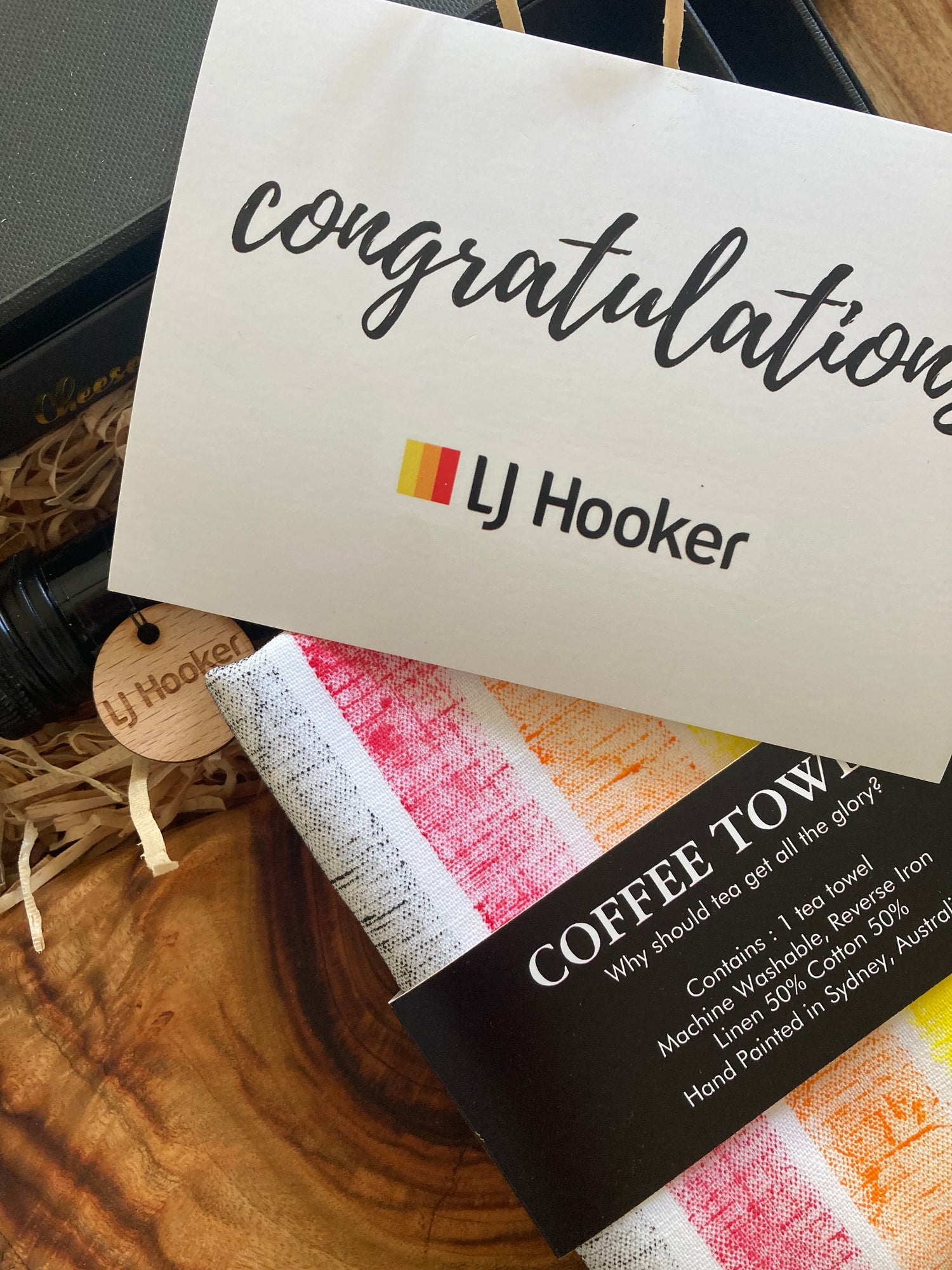 Branded Gift box. Branded Settlement gift for LJ Hooker showing laser engraved timber swing tag, painted linen towel and branded gift card.