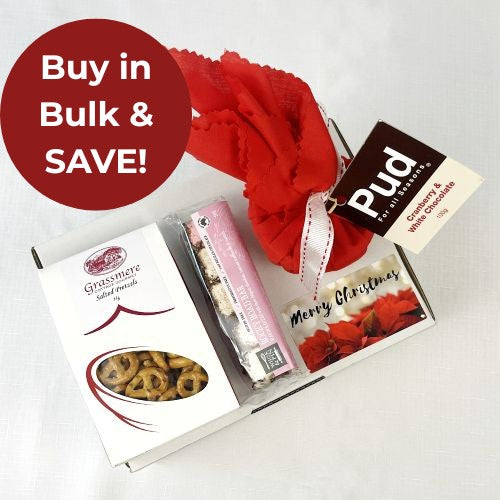 Gift box with pretzels, rocky road and Pud Christmas pudding in red fabric on a white background with a red circle and text 'Buy in Bulk & SAVE!' on a white background.