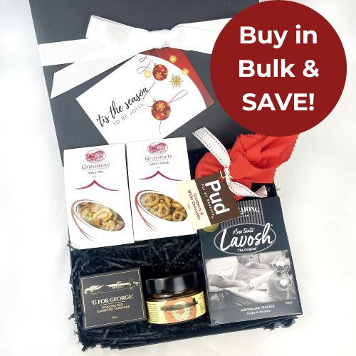 savoury christmas hamper including christmas pudding, crackers, tapenade and savoury snack in box on white background with a buy in bulk and save badge