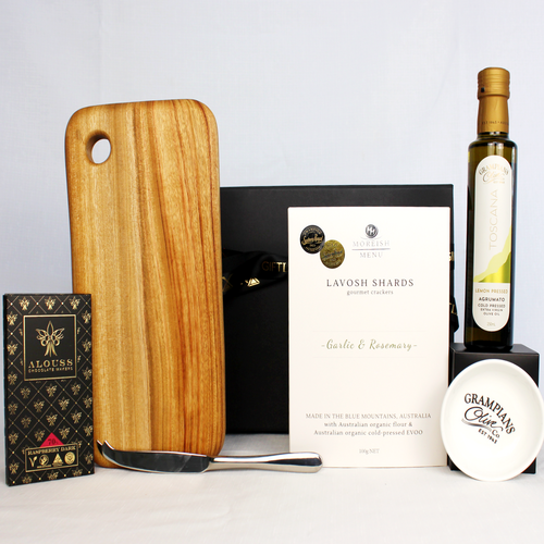 Handmade timber cheese board with cheese knife, Australian handmade chocolate bar, Infused olive oil with dipping bowl and lavosh shards in an elegant black magnetic gift box