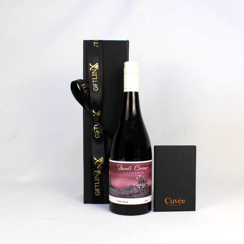 bottle of devils corner wine standing next to a black gift box with ribbon and a chocolate bar in a black box