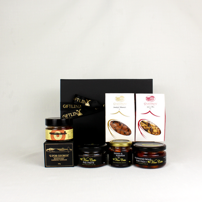 black git box standing alongside capsicum tapenade, smoked almonds, marinated figs and honey coated almonds
