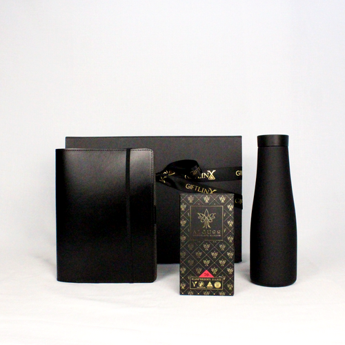 A luxury black magenetic gift box with ribbon containing an Australian made leather  notebook holder with pen loop and business card holder, matte black drink flask and handmade Australian chocolate bar.