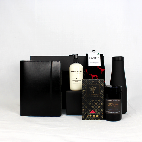 Recycled black leather notebook holder, matte black drink flask, loose leaf tea jar, australian ccocolate and australian botanical hand lotion packaged in a black gift box