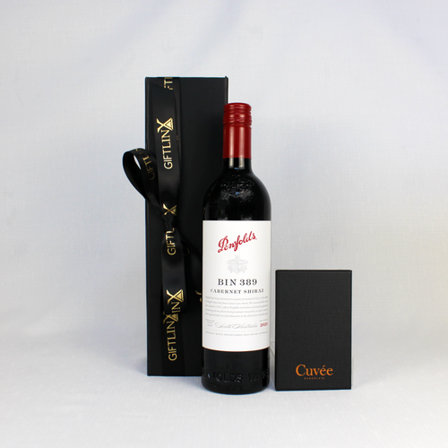 Penfolds BIN 389 Cabernet Shiraz wine standing next to a black gift box with ribbon and a box of chocolate