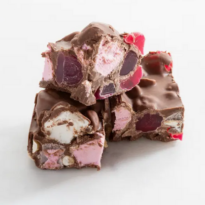 chocolate rocky road pieces stacked on each other with marshmallows and nuts