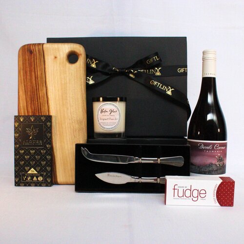 A gift hamper to show your gratitude including a handmade timber cheese board, stainless steel chese knife set, premium Autsralian chocolate, wine and a luxury soy candle jar
