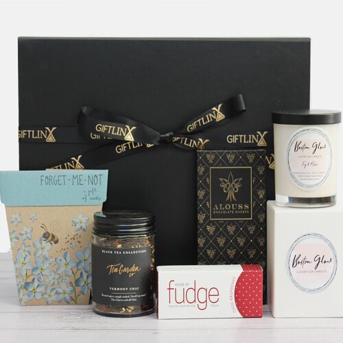 sympathy gift hamper including a luxury soy candle jar, Australian made premium chocolate and fudge, loose leaf tea blend and a packet of 'forget me not' seeds