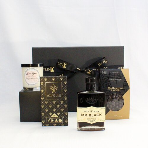 Coffee liquor with a box of chocolate coated coffee beans adn Australian chocolate bar alongside a luxury hand poured soy candle packaged in an elegant black gift box