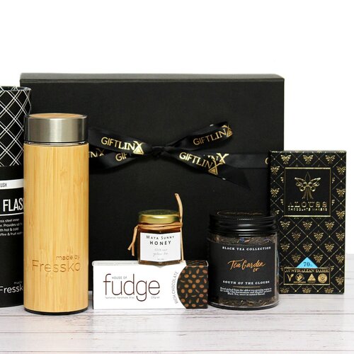Black and gold gift box and pamper hamper with a reusable bamboo flask, loose leaf tea blend, Australian honey and Australian made premium fudge and chocolate bar