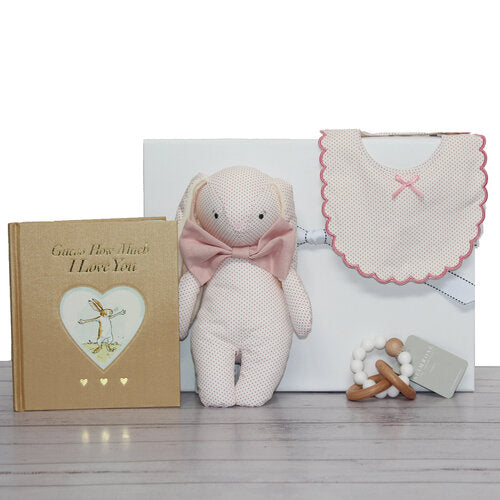 Baby girl gift hamper with pink bunny toy and baby bib, timber and silicone teether and "Guess how much I love you" baby book