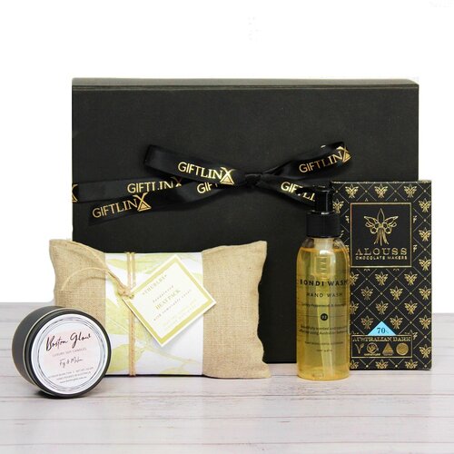 a care package gift hamper including a sandalwood heat pack, Australian made hand wash, premium Australian chocolate and luxury soy candle tin