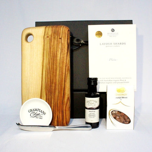 handmade timber board with lavosh crackers, infused olive oil and dipping bowl, smoked almonds and a cheese knife. Packaged in a black gift box with ribbon